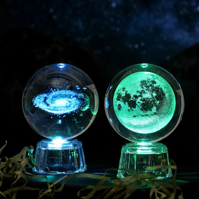 Transparent crystal ball ornament with inner carving of clouds, shown on a wooden table.