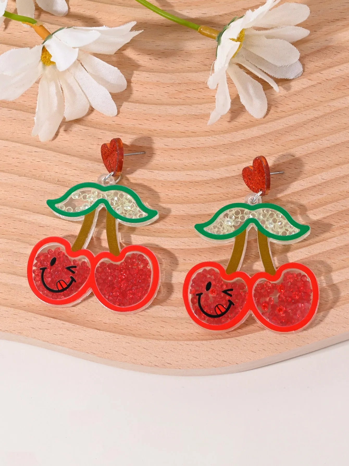 Colourful acrylic earrings with fruit and dessert designs including cherry, strawberry, watermelon, pineapple, coconut, cake and ice cream motifs