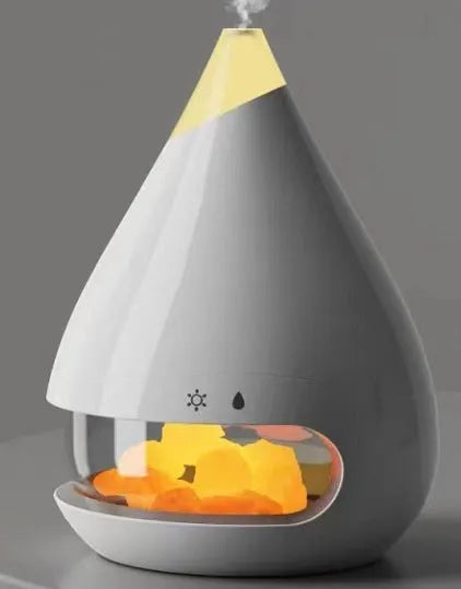 White square flame humidifier with colourful 3D light effect and crystal salt stone on a desk.