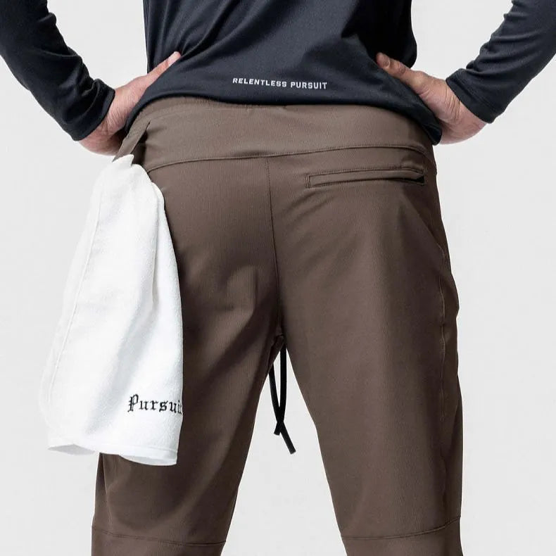 Men's grey fitness trousers with ankle ties, made from quick-drying polyester, for exercise and casual use.