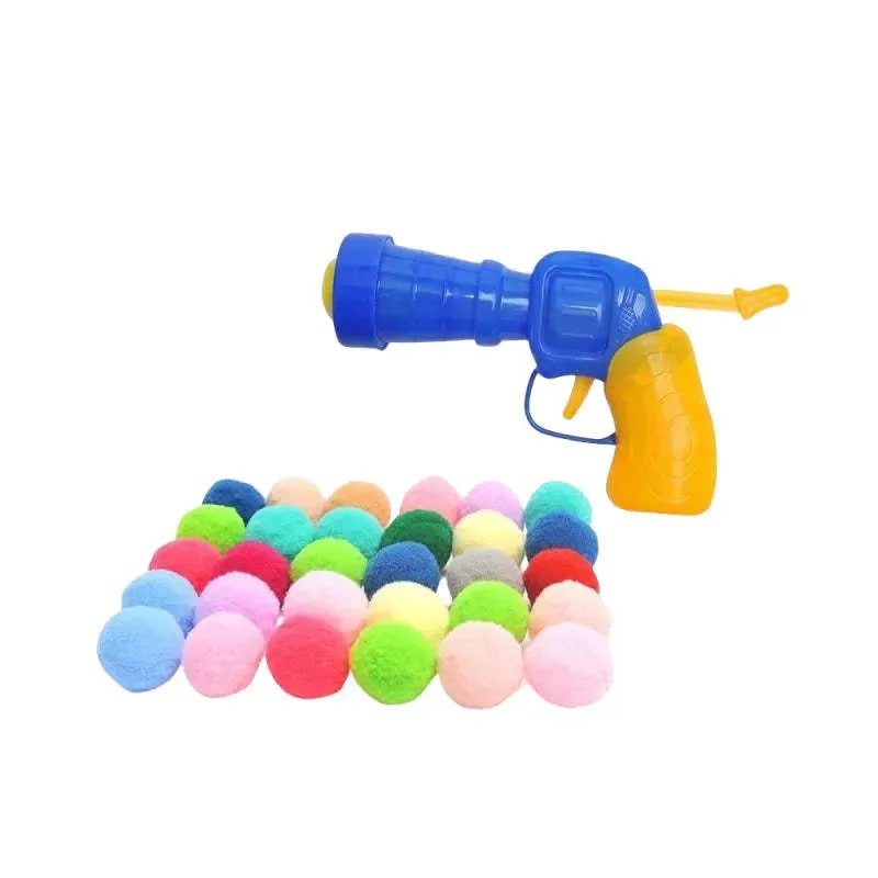Interactive plastic pet toy gun and soft plush yarn balls on a carpet for fetch games.