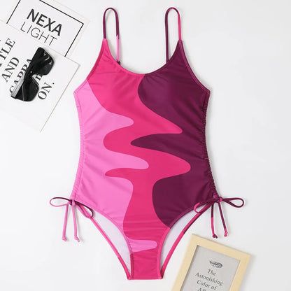 A blue one-piece swimsuit for women, showing sleeveless and backless design on a mannequin.