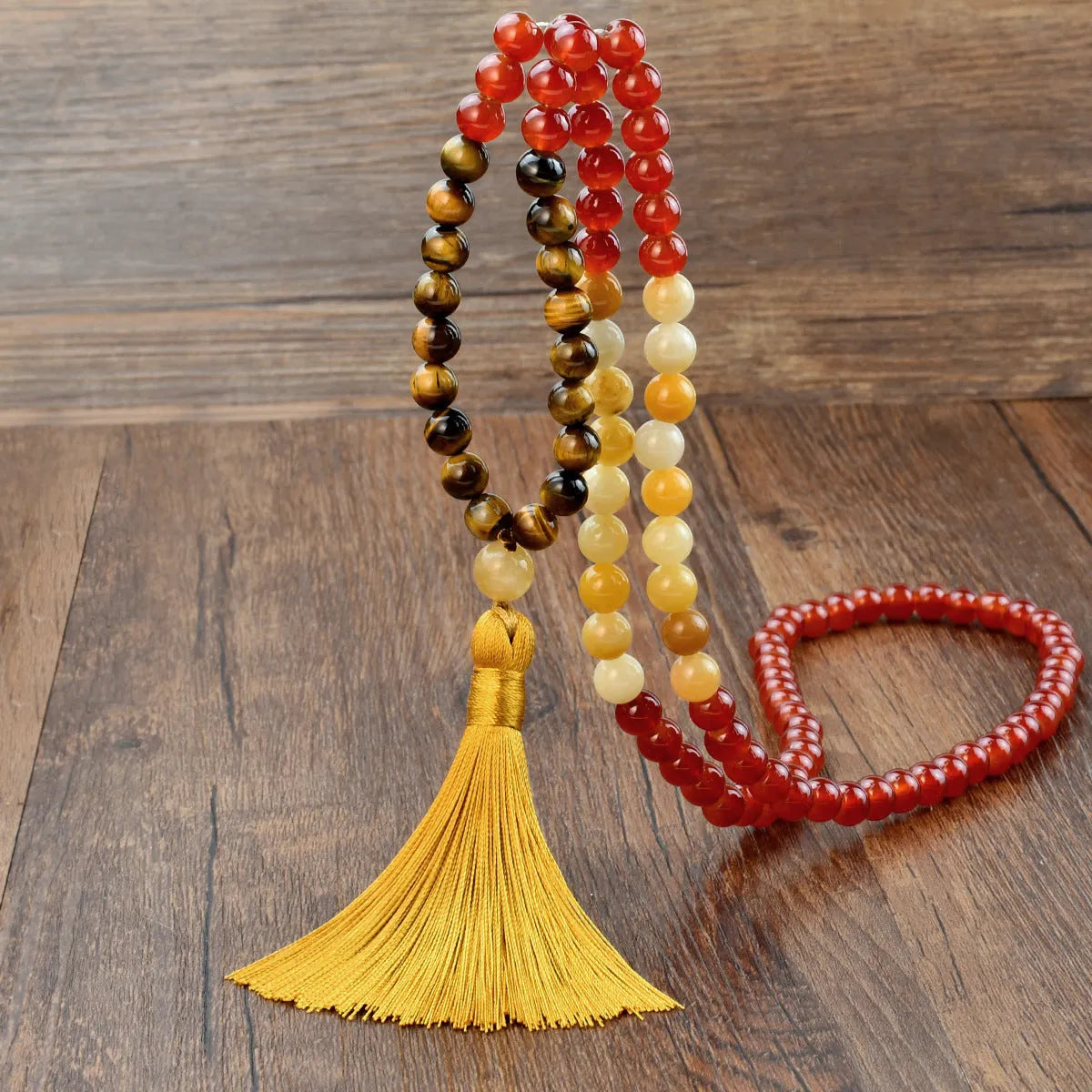 Long beaded necklace with geometric pendant and natural stone tassels in green aventurine.