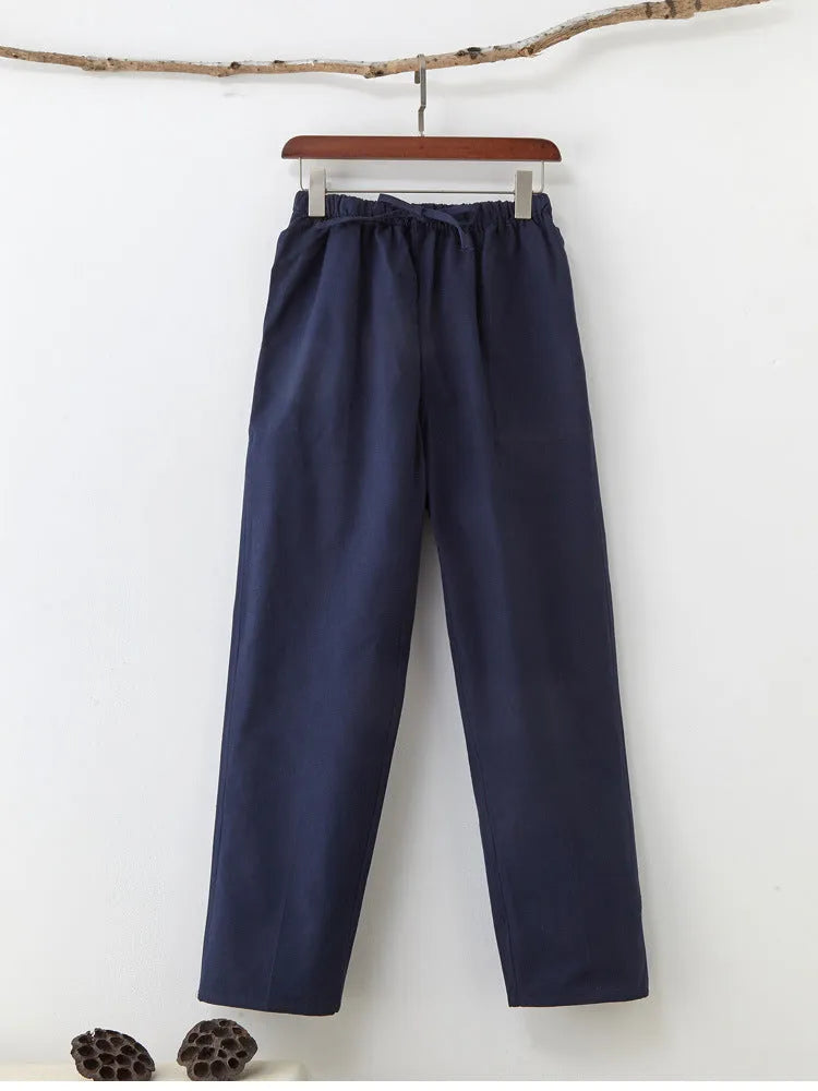 Men's beige pure cotton casual trousers with a drawstring waist on a mid-grey background.