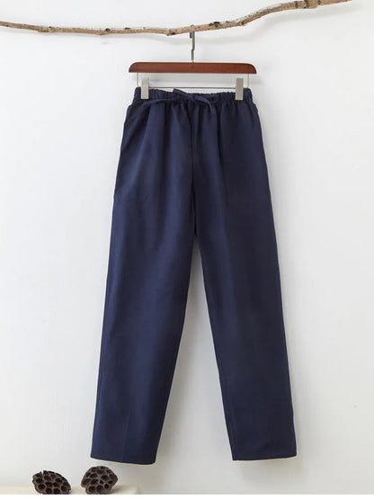 Men's beige pure cotton casual trousers with a drawstring waist on a mid-grey background.