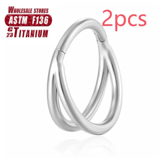 Pair of titanium alloy nose rings on a plain background showing silver, gold, black, and rose gold colour options.