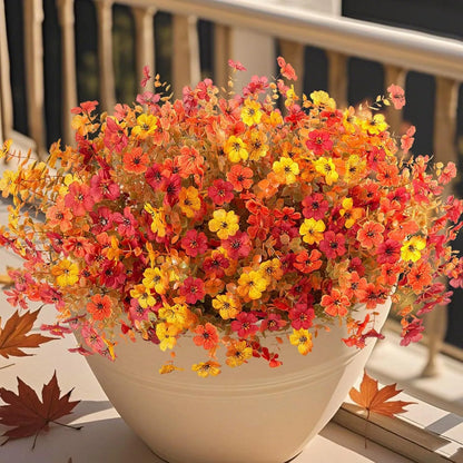 Autumn coloured artificial flower bouquet with plastic and silk flowers for decoration.