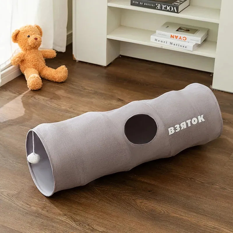 Collapsible brown or grey cat tunnel with a plush ball on top, shown in both extended and folded flat positions.