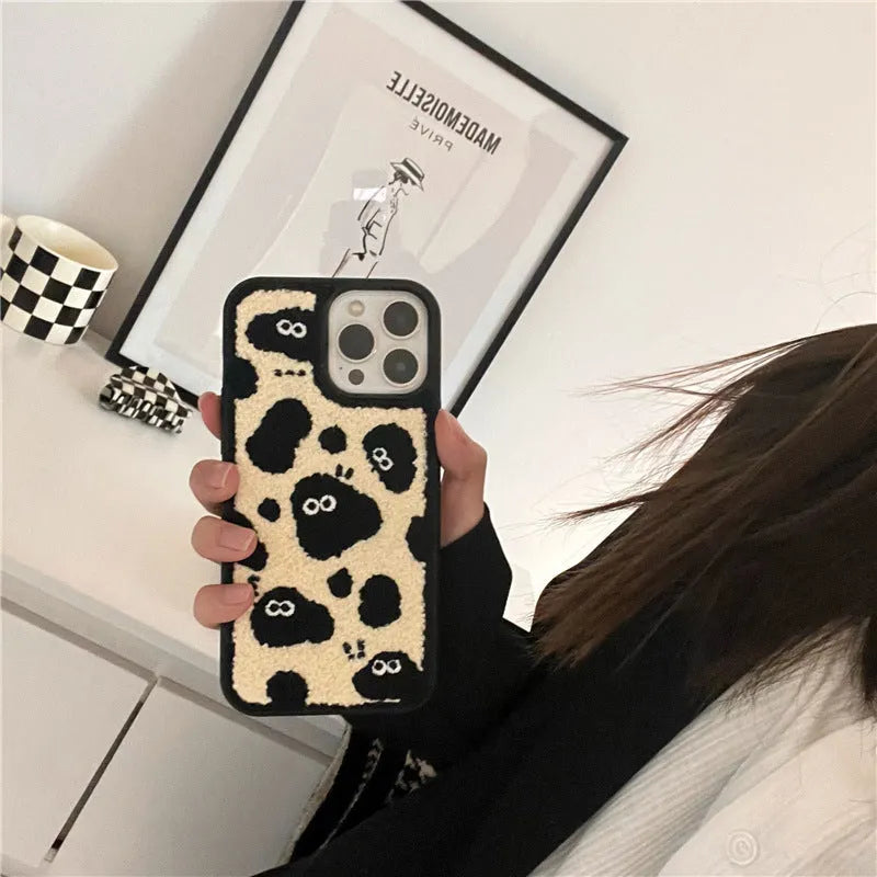 Black plush fairy character back cover case for Apple iPhone mobile phone.