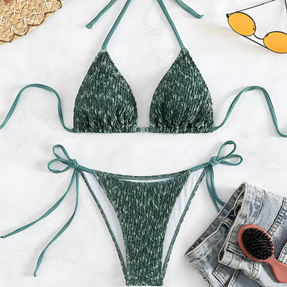 Women's green halterneck swimsuit with backless design and matching shorts