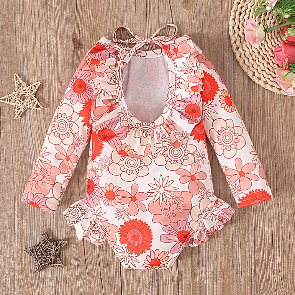 Girl's floral print swimsuit with crew neck and open back design in polyester fabric