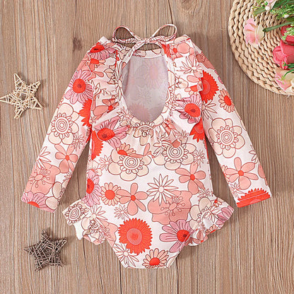 Girl's floral print swimsuit with crew neck and open back design in polyester fabric