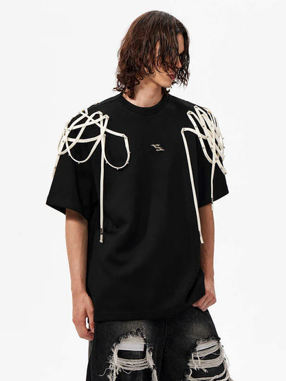 Black loose fit short sleeve t-shirt with padded shoulder detail on a hanger.