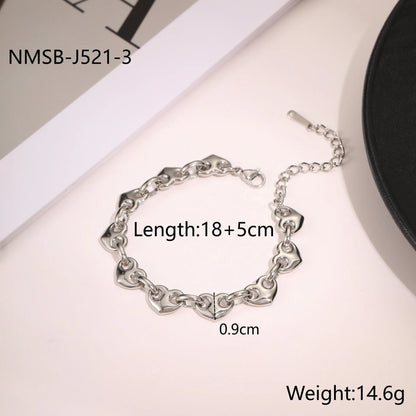Women's hollow heart bracelet in stainless steel with 18K gold plating, shown in colour block, gold, and steel finishes
