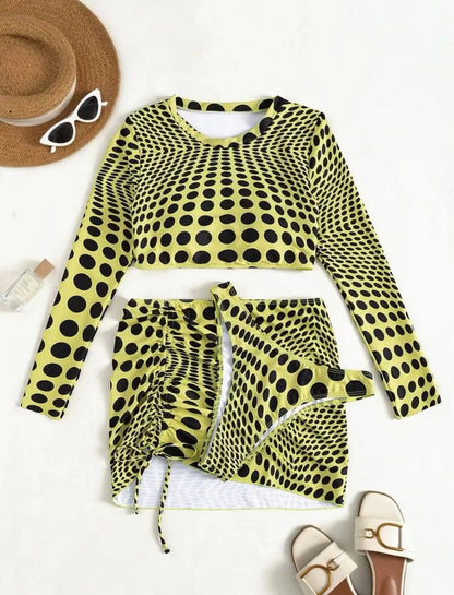 Green polka dot women's three-piece swimsuit set with top, skirt, and bra on hanger