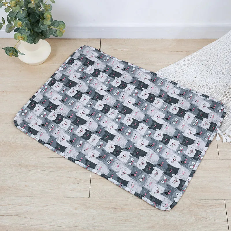 Reusable cloth pet urine pad with animal print and waterproof non-slip backing in various sizes.