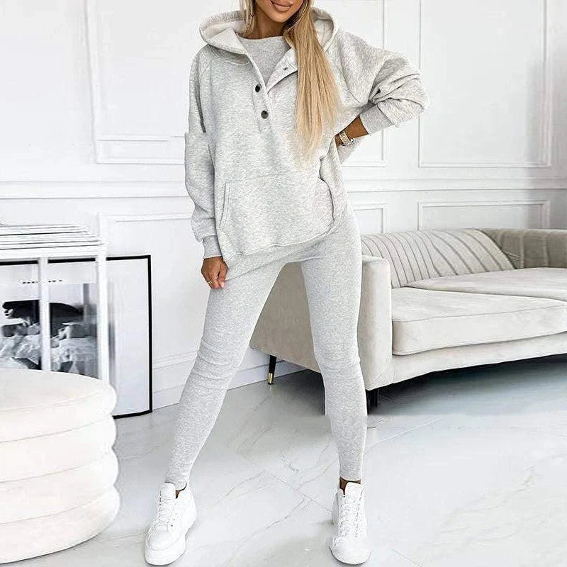 Women's 3-piece sports suit featuring a hooded sweatshirt with pockets and slim trousers
