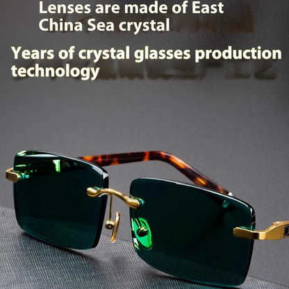Dark green frameless crystal glasses with sunshade lenses, case, and cloth