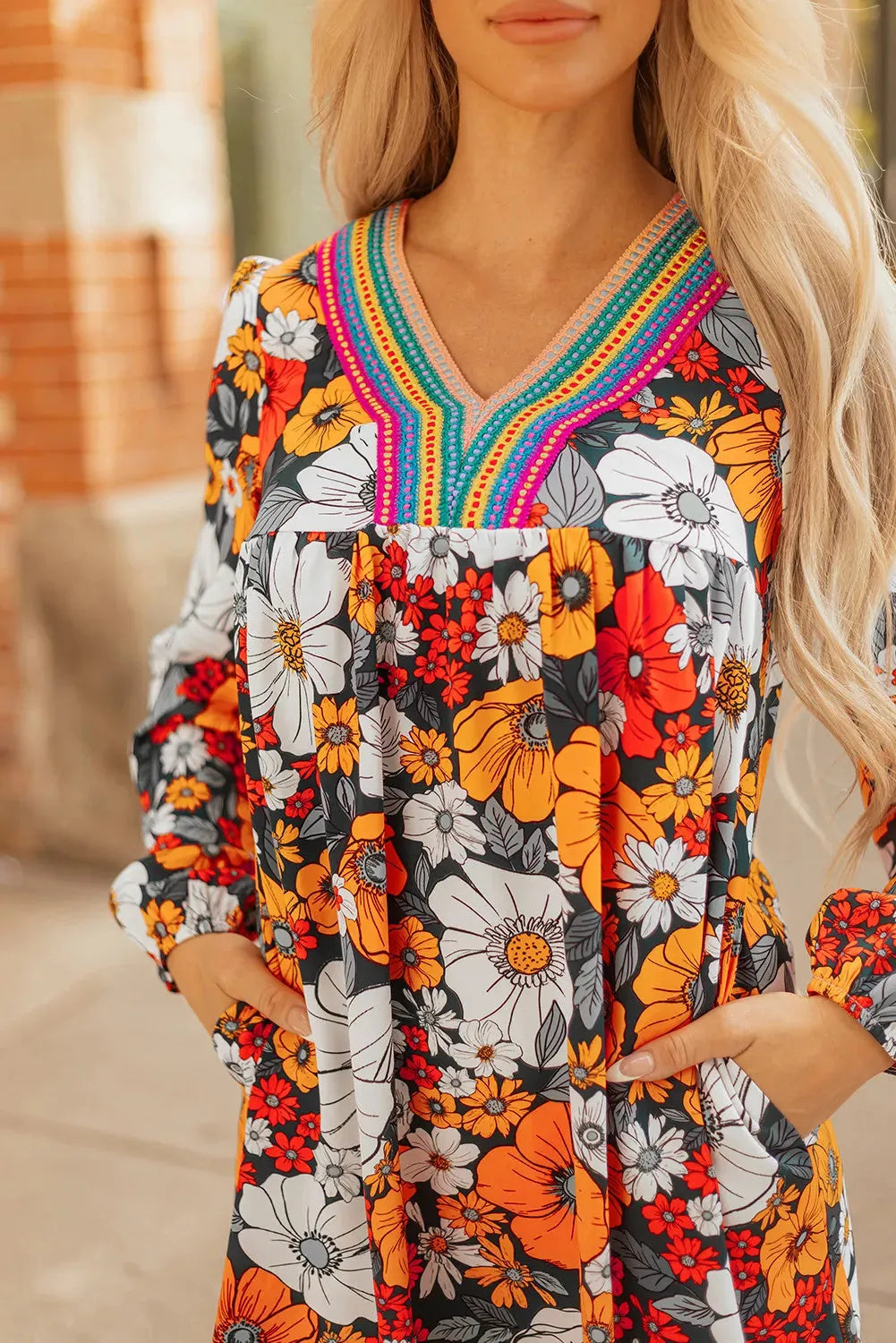Orange floral print mini dress with striped lace detailing, V-neck collar, and long sleeves