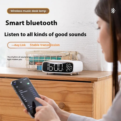 White Bluetooth speaker wireless charger with night lamp functions on wooden surface