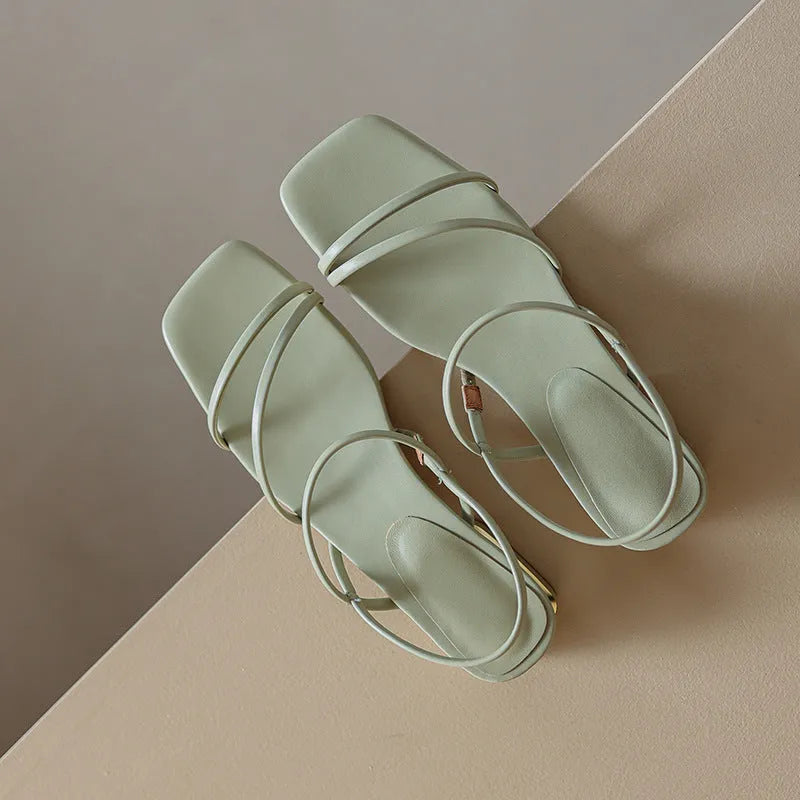 Women's flat strap Roman sandals with square toe in microfiber, showing adjustable ankle strap and multiple colour options