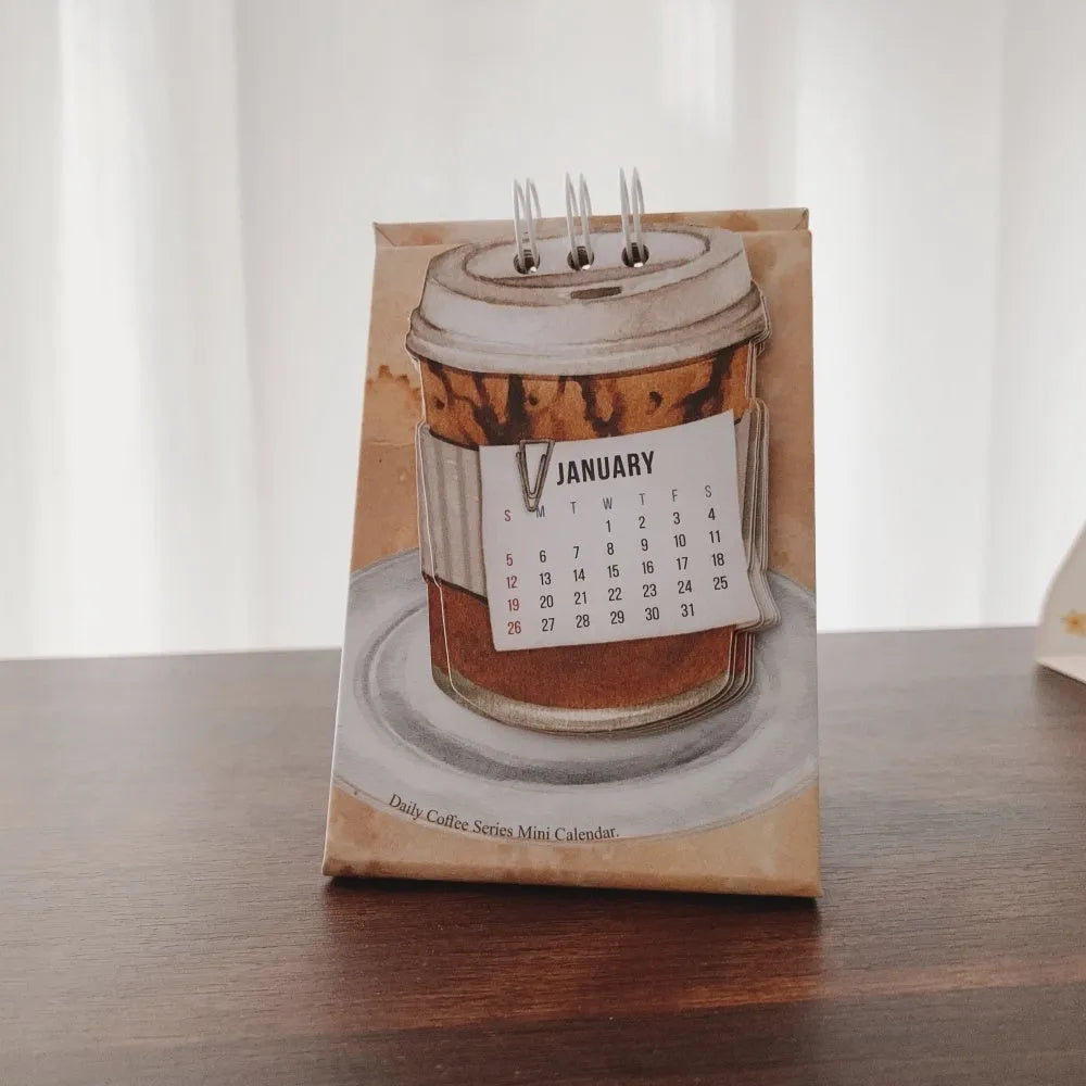 2025 mini desk calendar showing one of four designs: Coffee Time, Awake Time, Corner Perching, or Afternoon Lazy.