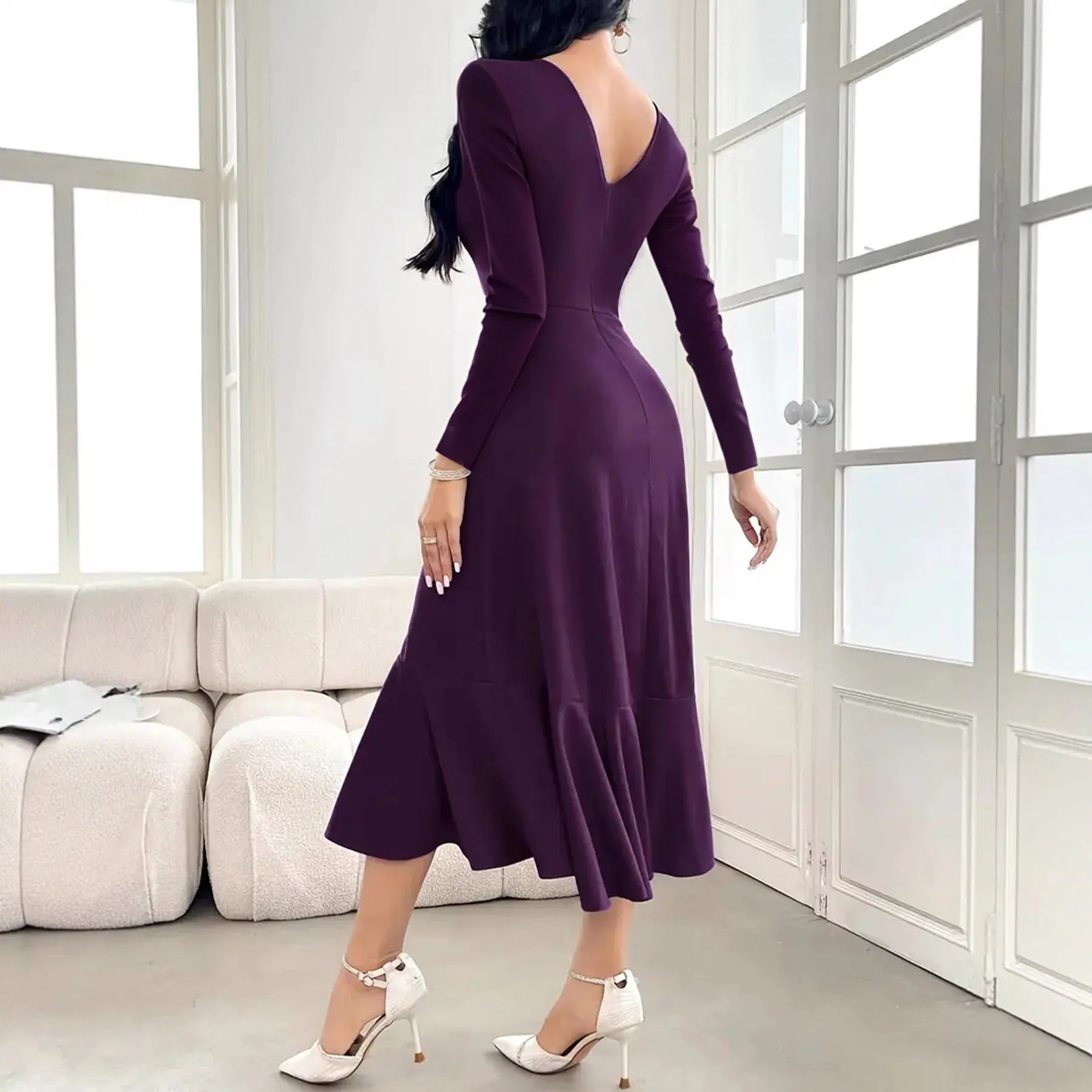Purple women's dress with long sleeves, round neck, and ruffle detailing on a mannequin