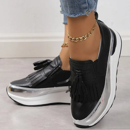 Women's black platform casual shoes with tassel detail and muffin wedge heel