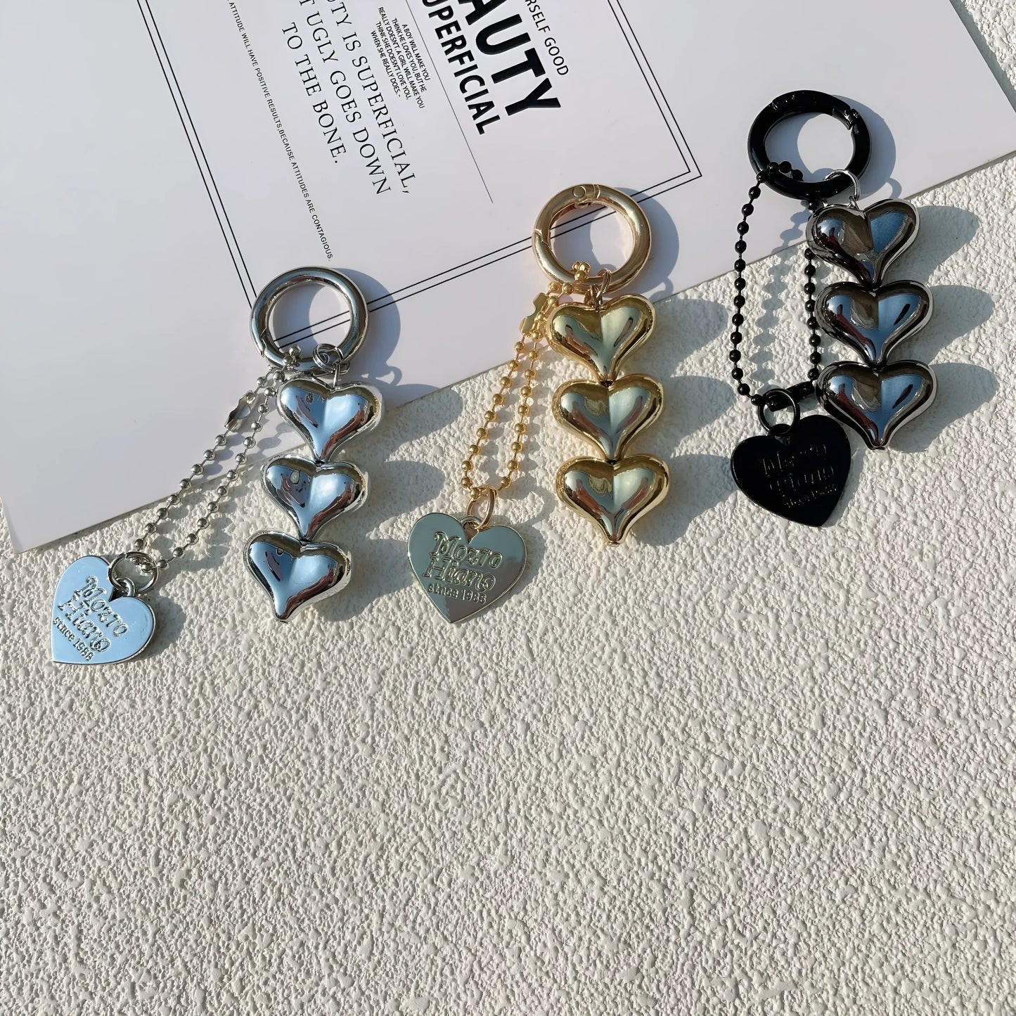 Acrylic key ring with an electroplated decorative charm in a choice of heart, bell, or water drop shapes.