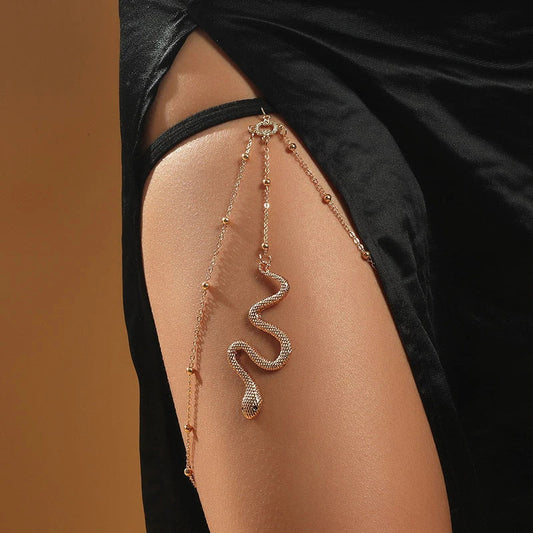 Glamorous Bohemian-style leg chain with snake pendant and metal beads, a unique and fashionable beach accessory
