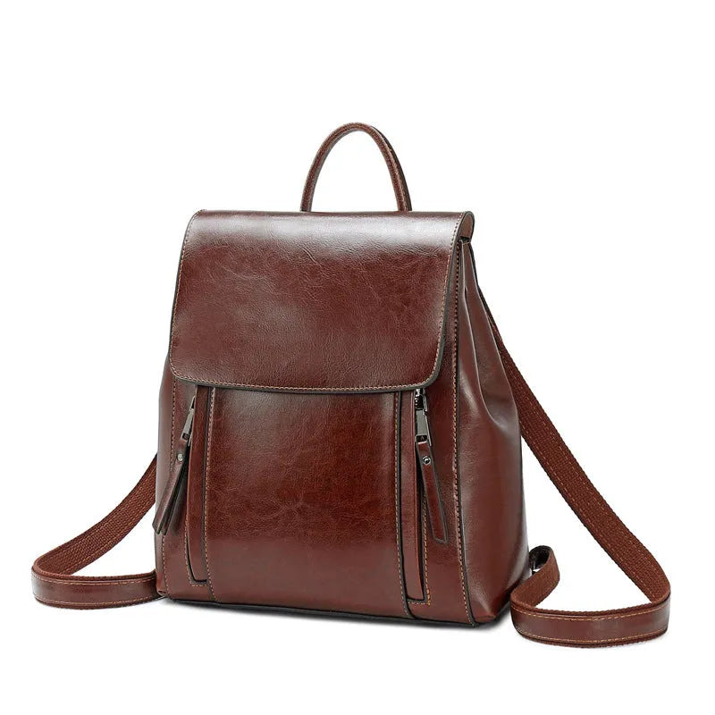 Genuine leather women's backpack with multiple compartments showing stitching details and cover-type opening