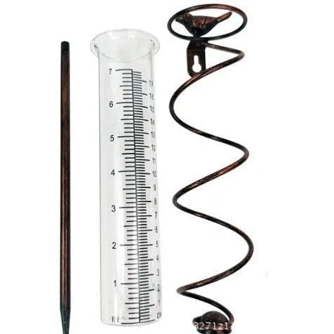 Cast iron hummingbird-shaped rain gauge with glass measurement tube showing 1-20 scale markings