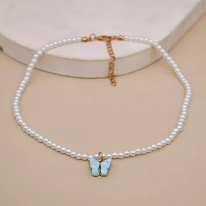 Elegant white pearl choker necklace with butterfly charm for women