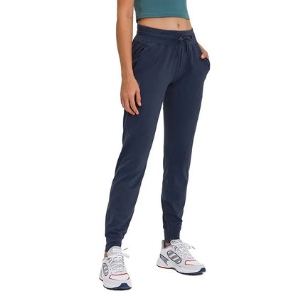 Women's high waist yoga pants with drawstring waistband in Belgian blue colour, showing stretch fabric during yoga pose