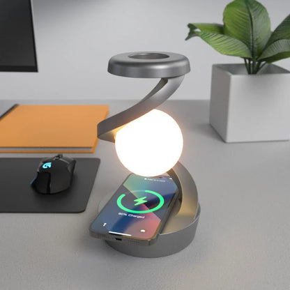 A rotating moon-shaped desk lamp with a wireless charging pad for smartphones, featuring a sleek and modern design.