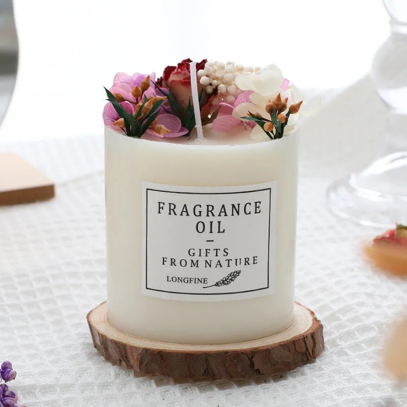 Aromatherapy candle with dried flowers on a wooden chip base, showing blue campanula and lavender scent options.