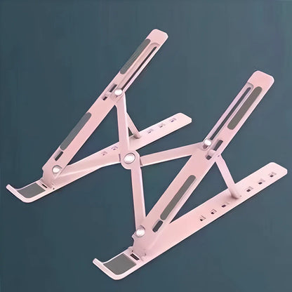 Silver aluminium alloy laptop stand folded slim, supporting 17.3-inch device with ventilation gaps and non-slip pads