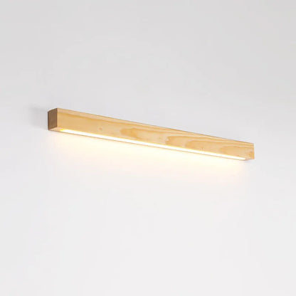 Walnut-coloured minimalist wooden strip wall lamp with integrated LEDs, mounted on a plain wall.