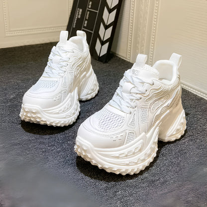 Women's white height increasing shoes with lace-up design and round toe, showing internal insole construction