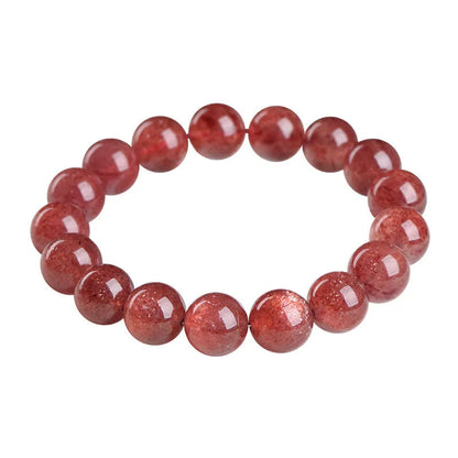 A polished strawberry quartz crystal bracelet in cherry red on a white background, showing geometric beads.