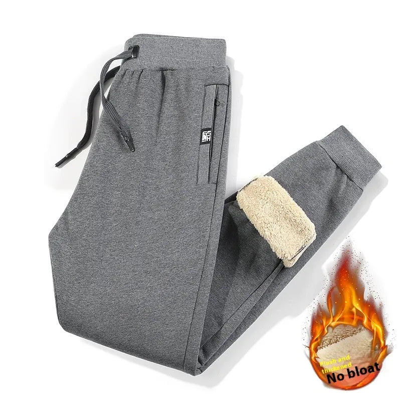 Grey fleece-lined men's cotton track pants with a drawstring waist shown in an oversized fit.