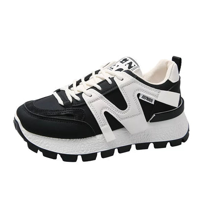 Women's low-top running sneaker in white or black with rubber sole