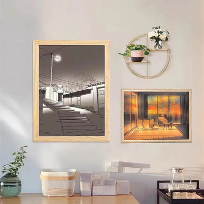 LED illuminated decorative picture light on a table showing a scenic landscape image glowing from within.