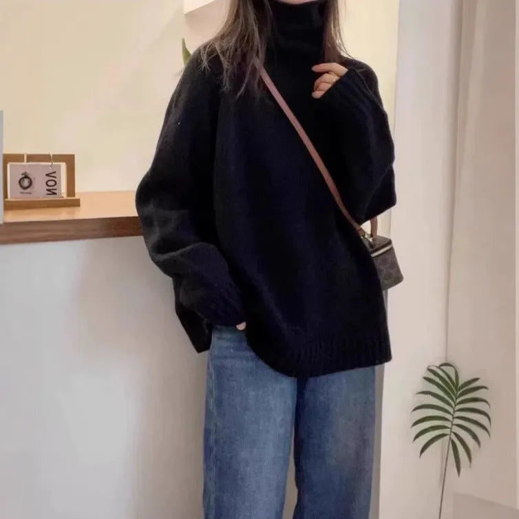 Women's turtleneck sweater in loose fit with thick curling pile collar, available in red, camel, grey, and black colours