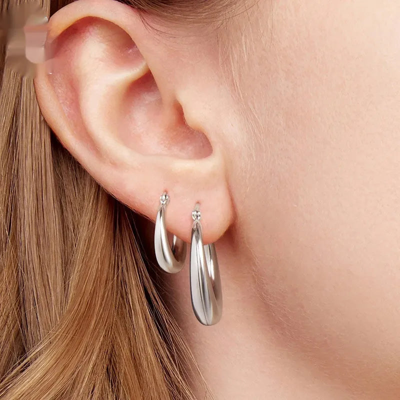 Copper alloy ear clip earrings with geometric ring design and silver posts in three sizes.