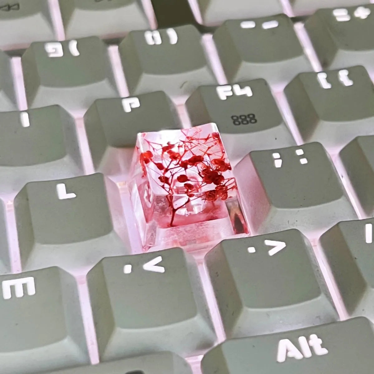 A transparent resin keycap with a starry sky design inside, shown in a green colour variant.
