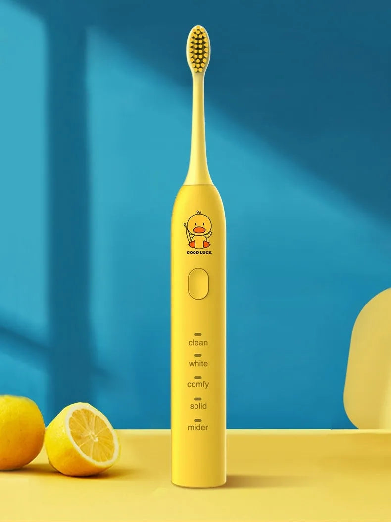 Yellow rechargeable electric toothbrush with small duck design, soft bristles and USB charging cable