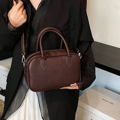 Retro square PU leather messenger bag with an adjustable shoulder strap in black colour.