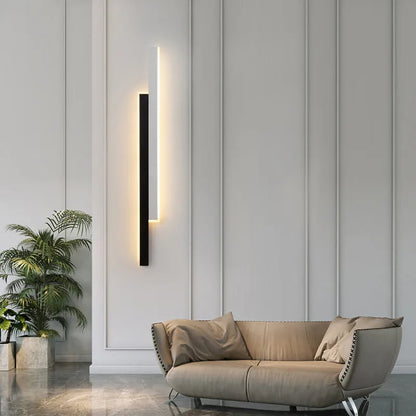 Modern strip wall lamp with acrylic shade mounted beside bed