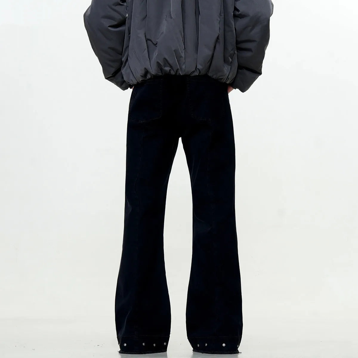 Pair of black straight-leg skinny jeans with a mid-rise waist and zipper fly on a neutral background.